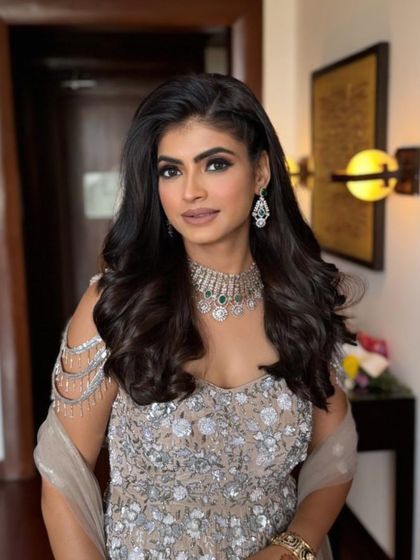 This angle highlights the beautiful side braid and the volume in her hair. It's a great hairstyle that keeps the hair off the face while still looking soft and romantic.