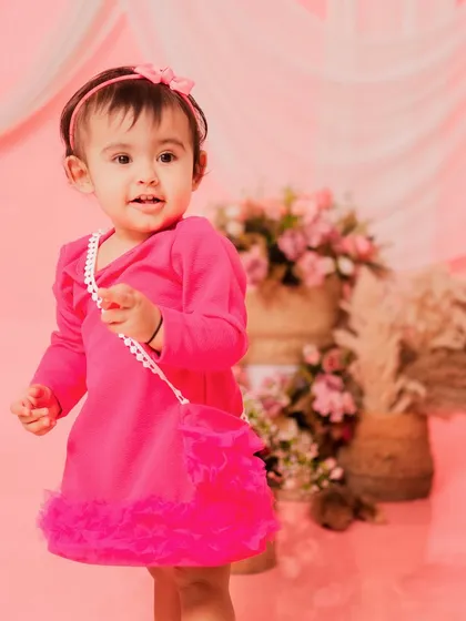 A stylish little girl in her bright pink dress. This portrait is full of personality and charm.