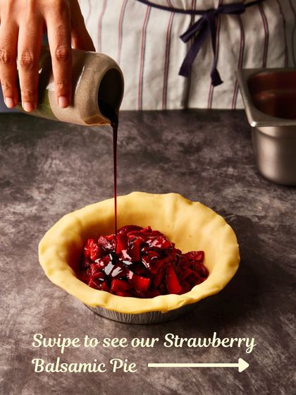 The first step in making our Strawberry Balsamic Pie: filling the buttery crust with roasted strawberries and balsamic glaze.
