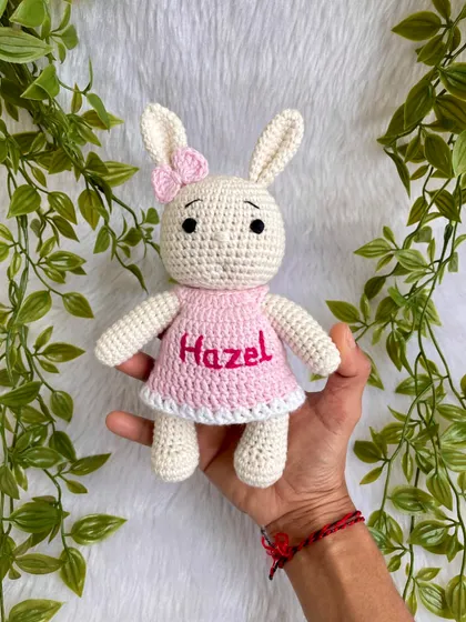 This bunny doll is personalized with the name "Hazel" on her pretty pink dress. Customizing a doll with a name makes it an extra special and personal keepsake.