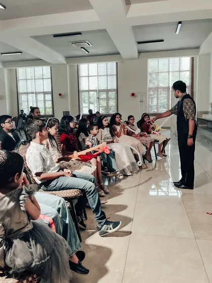 A shot from a birthday party magic show, where I'm interacting with the front row. Even in a more formal seated arrangement, I make sure to move around and connect with as many kids as possible.