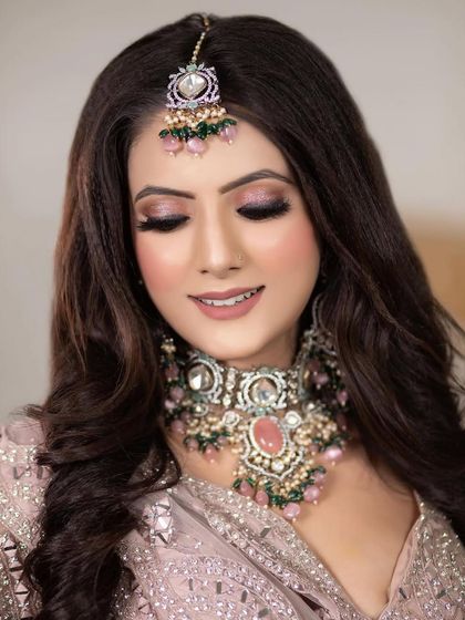 A smiling close-up of the model, showing how the soft glam makeup creates a radiant and youthful glow.