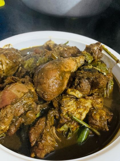 A bowl of my special chicken curry cooked with Aneshi and other Naga herbs. This dish has a deep, earthy flavor that is very authentic.