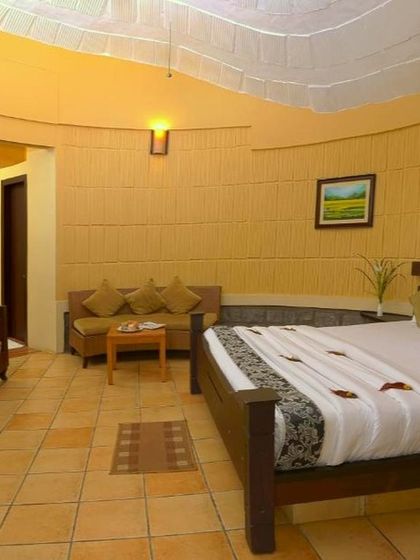 The spacious and tastefully decorated interior of a room at Riverside Nature Resort, offering a comfortable and luxurious stay.