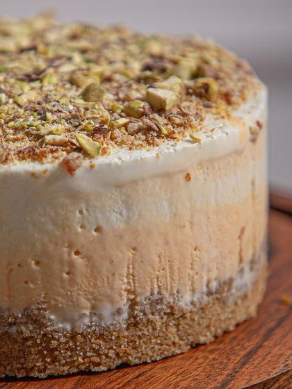 A close-up of a pistachio-crusted ice cream cake, showing the thick, creamy layers and crunchy topping. Pure bliss in every bite.