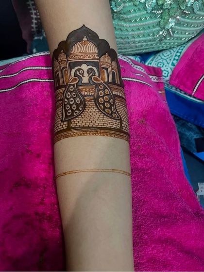 A simple yet elegant armband design featuring two peacocks in front of a palace facade, perfect for someone who wants a unique motif.