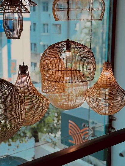 Our collection of handcrafted wicker pendant lights adds a touch of rustic, coastal charm to the modern interiors, casting a warm and inviting glow over the dining space.