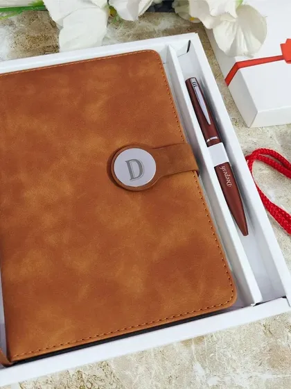 A closer look at the Camel Brown diary set, showing the fine details of the personalized pen and the magnetic lock. The diary contains 200 lined pages and a calendar, making it a very useful gift.