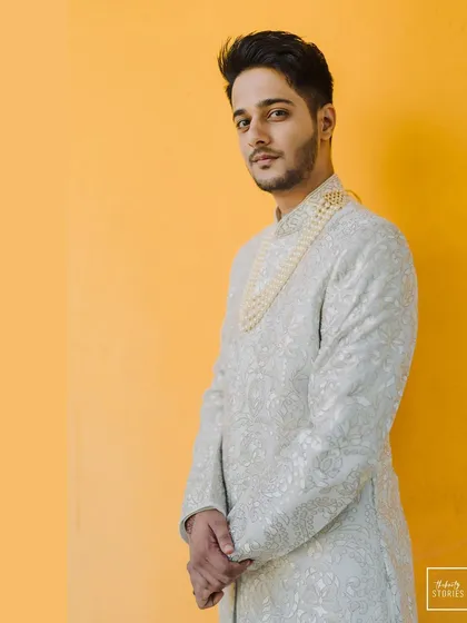 A duplicate of 302, another take on the groom's dapper portrait against the yellow backdrop.