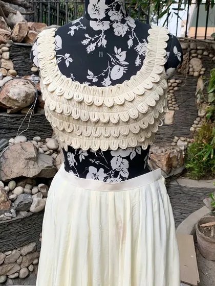 This scalloped blouse is a conversation starter. You can zoom in to see the delicate work that makes this piece an art.