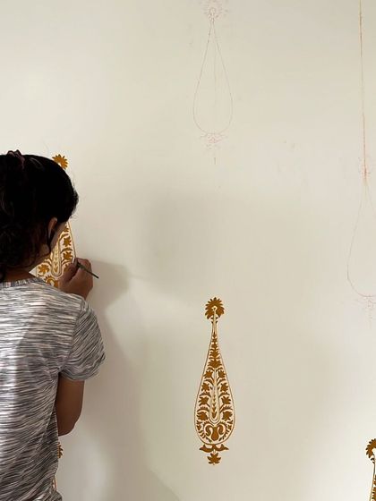 My team member carefully painting the intricate paisley-inspired motifs. This work requires a steady hand and immense patience to ensure each element is perfect.