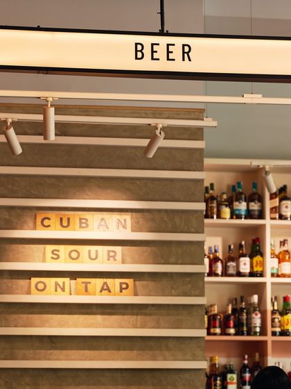 The "BEER" sign highlights our selection of draft options, including the unique "CUBAN SOUR ON TAP," a testament to our innovative approach to drinks.