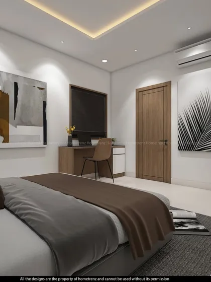 A view of the bedroom focusing on the art and the simple, modern desk setup, perfect for a teenager or a guest room.