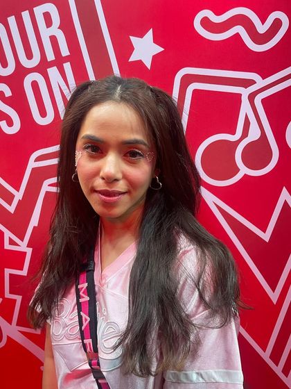 A client with a cute pink outfit and subtle glitter accents. The small heart and liner details are perfect for her look.