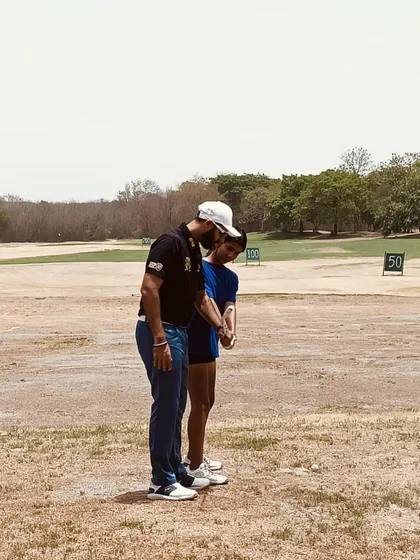 A hands-on moment during a lesson at the summer camp, focusing on setup and posture.