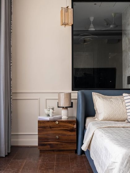 With a foundation of warm textures and light hues, this bedroom layers in details that speak of sophistication. The hand-painted wallpaper and intricate trims on the furnishings create a balanced and bespoke feel.
