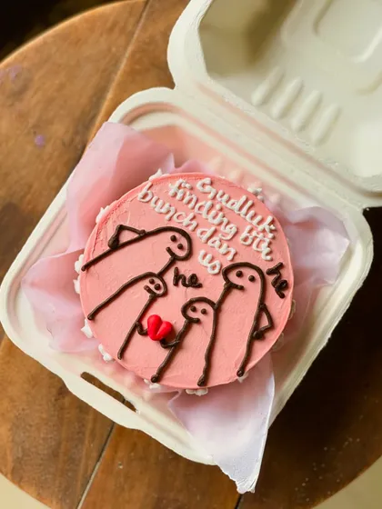 A funny and sweet cake for a couple, featuring a family of meme characters with the Hindi text "Gudluck finding bunchdan us," a playful take on finding a better match.