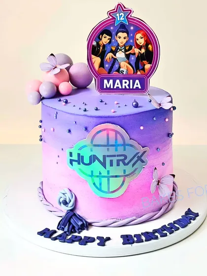 For the K-Pop fans, this Huntrix: K-Pop Demon Hunters cake features a vibrant purple and pink ombre design with a holographic logo. It's a trendy and exciting cake for a tween's birthday celebration.