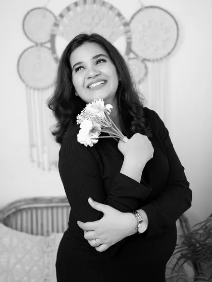 A dreamy black and white portrait. The mother-to-be looks up thoughtfully, creating a beautiful and contemplative image.