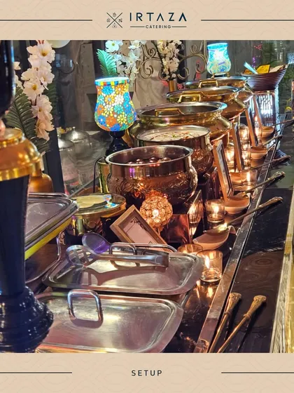 A chaotic but beautiful close-up of a busy buffet table after service has begun. The mix of silver trays, golden pots, and colorful decor shows a vibrant and well-loved food station.