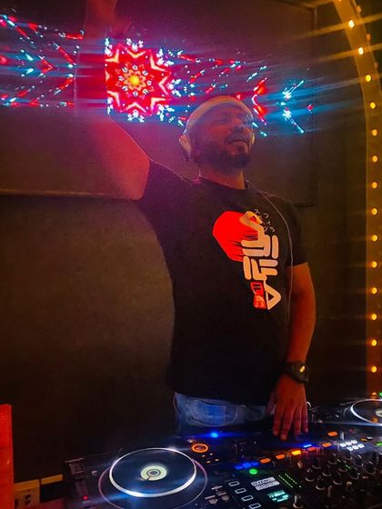 Feeling the music under the vibrant lights at Bombay Cartel. It's about creating a complete sensory experience.