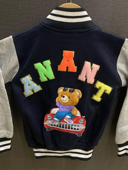 A super cool personalised varsity jacket for a little dude. We used colorful chenille letters for his name and a fun patch of a bear driving a car.