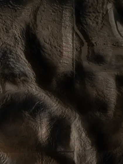 The texture of the mountain wall installation is designed to capture light and shadow, mimicking the dramatic, undulating surfaces of the Himalayas. This detail brings a tangible sense of the natural world into the hotel's interior.