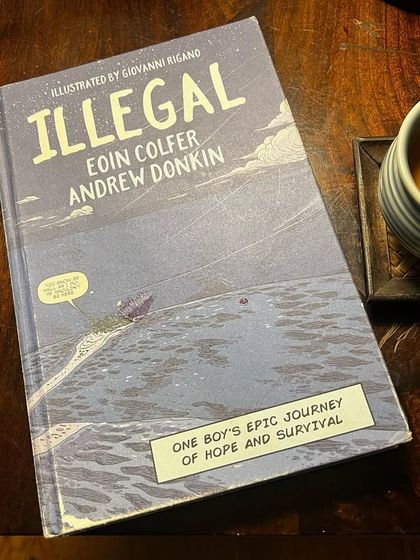 A copy of the book 'Illegal'. It has been on some banned book lists, which highlights how socio-political factors can influence access to information. I believe in the power of books to open our minds to difficult but necessary conversations.