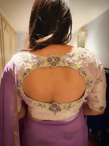 I was so honored to design for the gorgeous actress Divya Spandana. This is the back of the custom raw silk blouse I created for her, featuring a unique keyhole cutout framed with delicate spring flower embroidery. It shows how a simple detail can create a truly memorable piece.