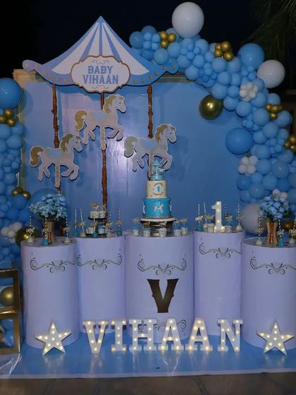 The carousel theme decoration after sunset, with the marquee letters and other lights creating a warm and inviting glow.