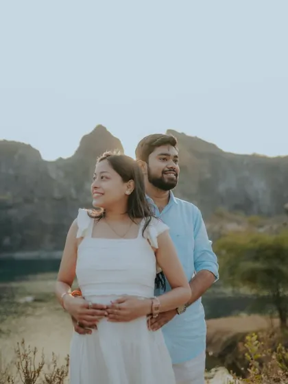 Looking towards a shared future, surrounded by stunning mountain scenery. A candid moment from a pre-wedding shoot at a picturesque lakeside location.