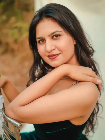 A beautiful close-up portrait in an outdoor setting. The soft, natural light highlights the model's features and creates a warm, inviting mood.