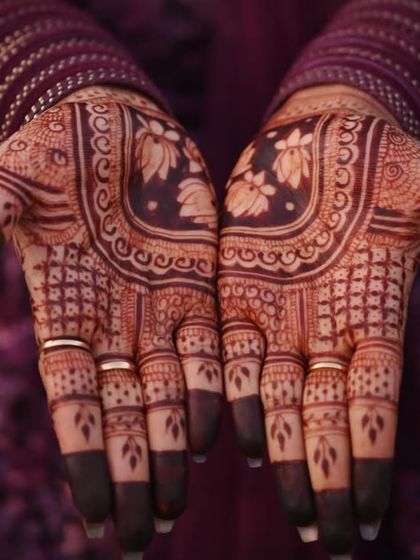 A full view of the stained palms, showcasing the intricate floral and geometric patterns in a deep, beautiful color.