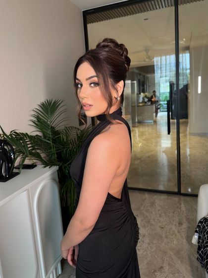 A voluminous and intricate topknot for a glamorous evening look. This style adds height and drama.