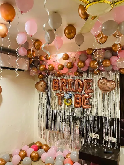 Another angle of the rose gold 'Bride to Be' party setup. This view shows how the ceiling balloons and the main backdrop work together to fill the space and create a festive, photo-ready environment.