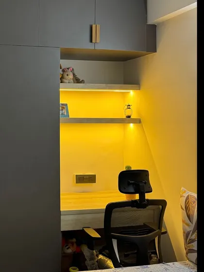 A closer look at the integrated study nook, showing the desk space, power outlets, and warm ambient lighting.