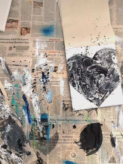 A behind-the-scenes look at my messy workspace while creating the black and white heart painting. The process is just as important as the final piece.