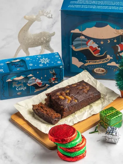 The 'Holly Jolly' hamper, a delightful combination of our rich plum cake and a pack of six chocolate-coated biscuits.