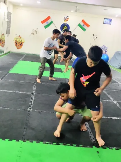 Practice doesn't make perfect, but it makes you more efficient. These kids are drilling wrestling takedowns, learning the importance of repetition in mastering a skill.