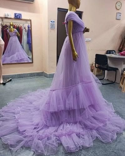 A side view of the lavender gown, highlighting the length of its beautiful train and how it drapes on the floor.