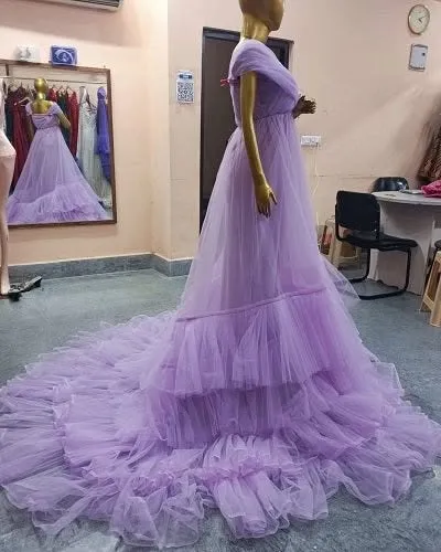 A side view showcasing the long, dramatic train of our lavender ruffled gown. This dress is designed to make a statement from every angle.
