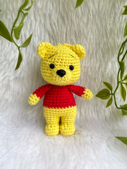 A sweet Winnie the Pooh keychain. This classic character is perfect as a small, adorable accessory to hang on a bag or keys, bringing a little bit of the Hundred Acre Wood with you.