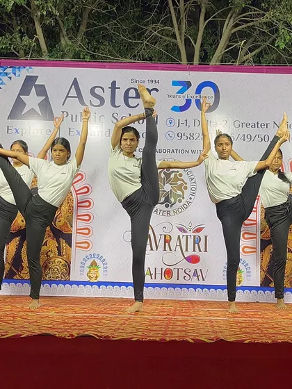 A powerful standing split pose performed in unison, showcasing the strength and flexibility of my performance team.