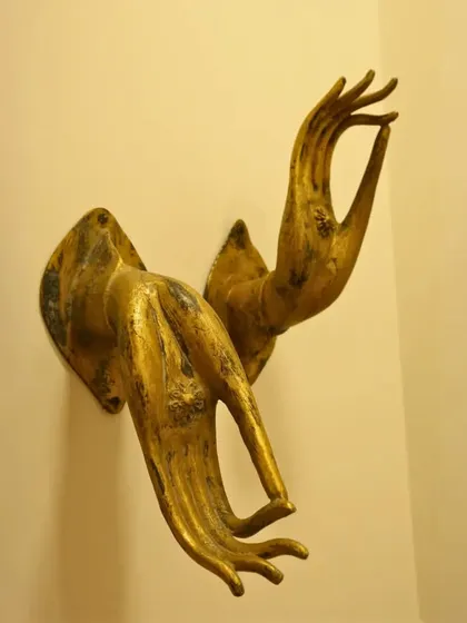 These golden, sculpted hands in a mudra (a symbolic gesture) serve as unique wall decor. They bring a sense of peace and mindfulness, turning a simple wall into a statement of spiritual elegance.