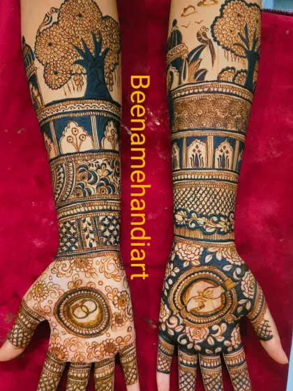 A beautiful engagement mehandi design. The arms feature trees and birds, while the palms have ring symbols and other traditional patterns.