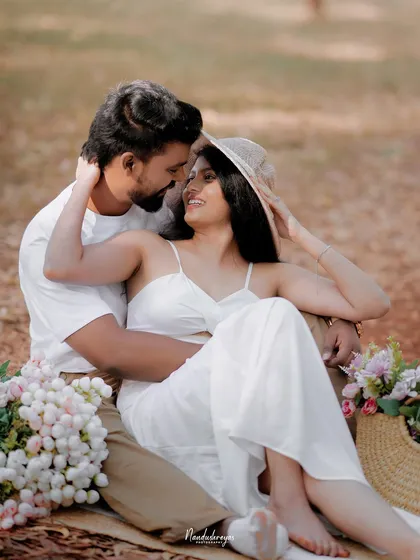 A playful and loving close-up of a couple during their picnic, capturing a genuine smile and connection.