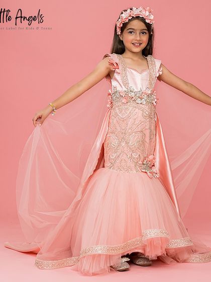 The Peach Ayesha Gown is a stunning mermaid style dress with a long, dramatic train and floral embellishments.