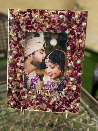 A side view of the orchid petal photo frame, showing the depth and detail of the preserved flowers. Each petal is carefully placed to create a beautiful, textured border.