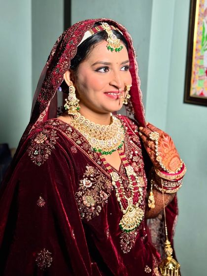 Another angle of this beautiful bride, showing her radiant smile and the detailed jewelry that completes her traditional look.