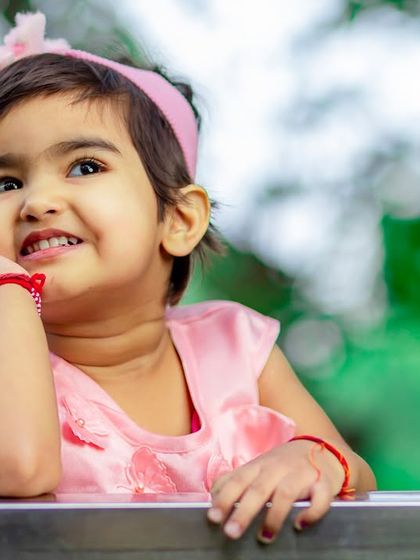 A charming outdoor portrait of a little girl with a thoughtful and happy expression. I love capturing these candid, personality-filled moments during a kids portfolio session.